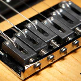 Bustin’ a Dinger: How Graph Tech String Saver Saddles Alleviate String Breakage